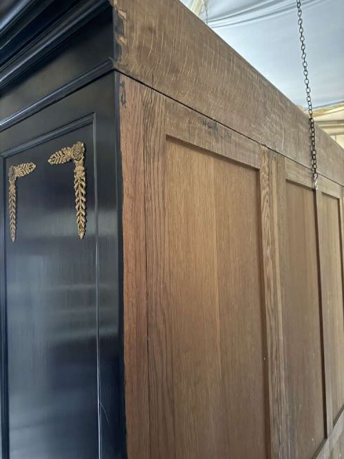 A large late 19th-century French Empire style ebonised bookcase with three arched glass doors, gilt bronze mounts, and light oak shelves. View VII
