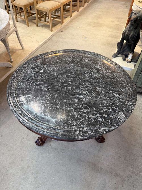A 19th-century French circular gueridon table featuring a dark grey veined marble top resting on a carved mahogany pedestal base with carved feet. View II