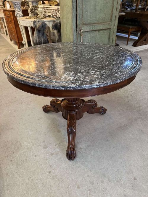 A 19th-century French circular gueridon table featuring a dark grey veined marble top resting on a carved mahogany pedestal base with carved feet. View VIII
