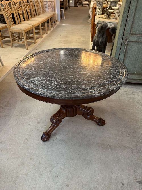 A 19th-century French circular gueridon table featuring a dark grey veined marble top resting on a carved mahogany pedestal base with carved feet. View IX