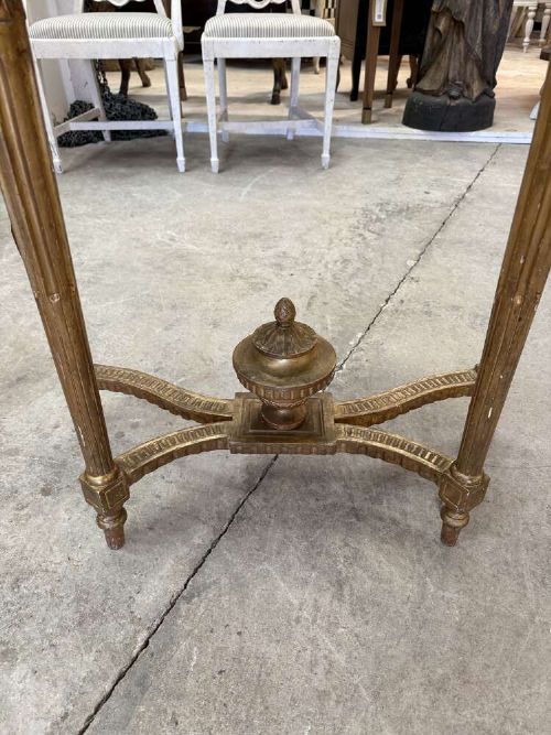 A late 19th-century French Louis XVI style demi-lune console table featuring a dark marble top, carved gilded legs, and a central urn finial. View II