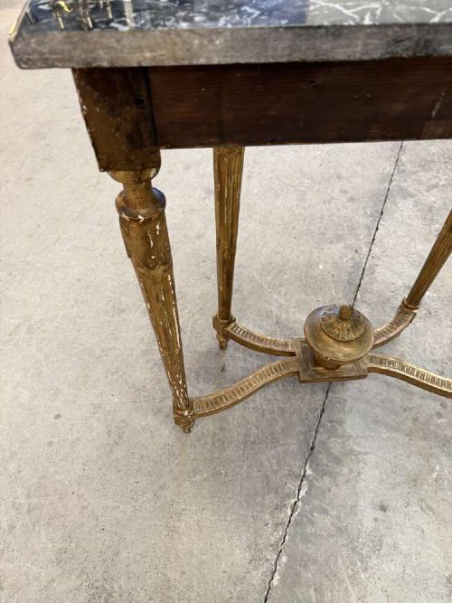 A late 19th-century French Louis XVI style demi-lune console table featuring a dark marble top, carved gilded legs, and a central urn finial. View VIII