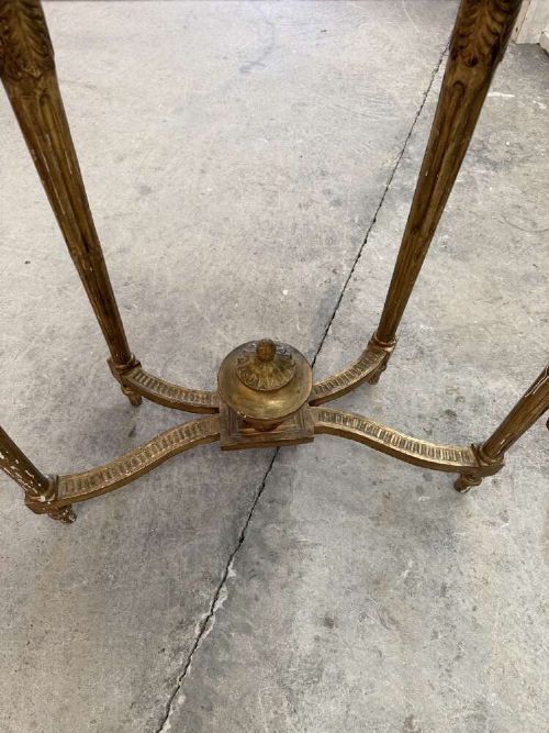 A late 19th-century French Louis XVI style demi-lune console table featuring a dark marble top, carved gilded legs, and a central urn finial. View IX