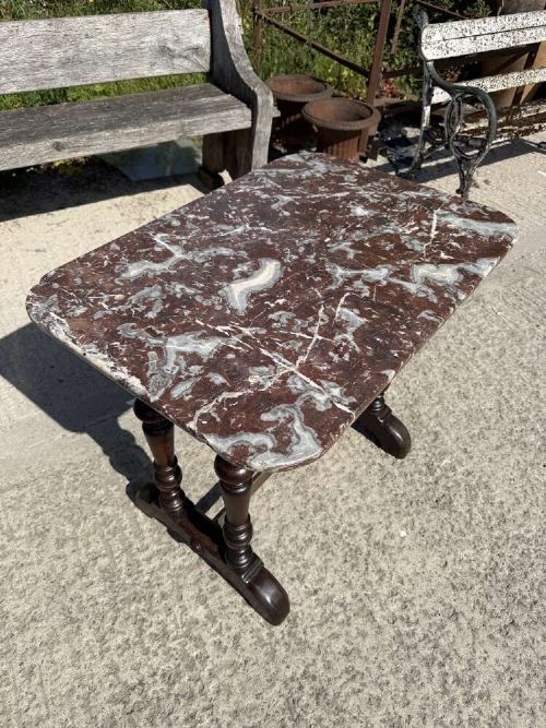 A 19th-century French table a gibier featuring a red and grey veined marble top resting on a dark turned timber base with a low stretcher. View II