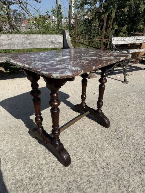A 19th-century French table a gibier featuring a red and grey veined marble top resting on a dark turned timber base with a low stretcher. View III