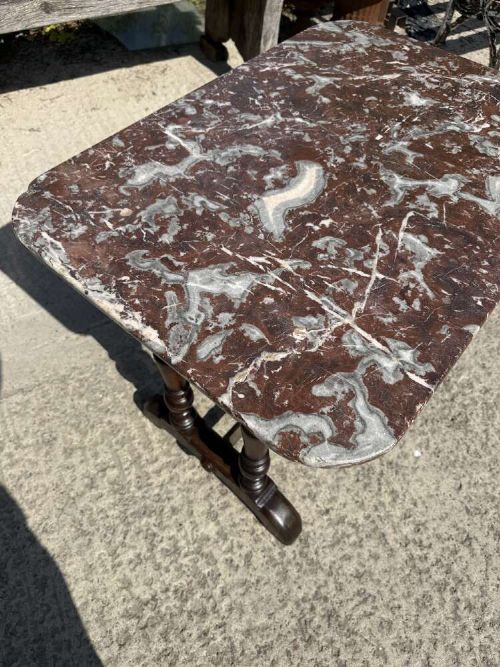 A 19th-century French table a gibier featuring a red and grey veined marble top resting on a dark turned timber base with a low stretcher. View V