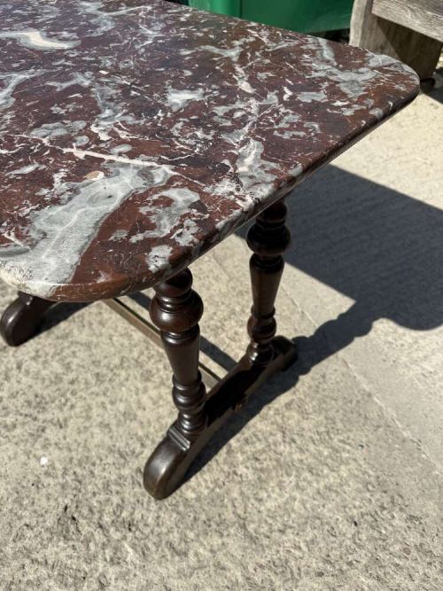 A 19th-century French table a gibier featuring a red and grey veined marble top resting on a dark turned timber base with a low stretcher. View X