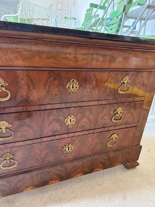 A nineteenth-century mahogany commode featuring three drawers with decorative brass handles and a dark marble top. View III