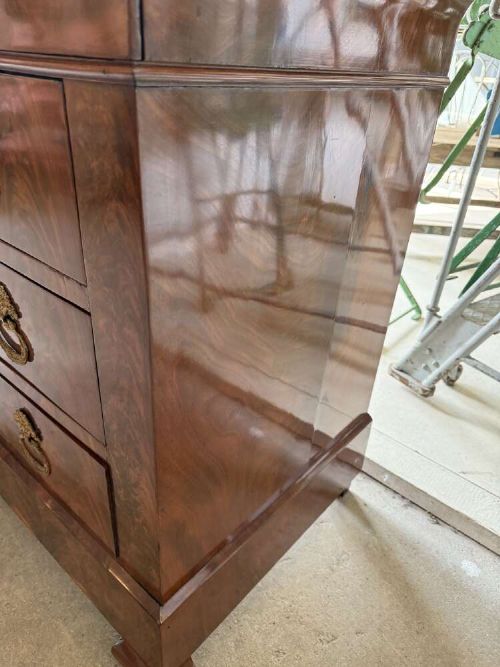 A nineteenth-century mahogany commode featuring three drawers with decorative brass handles and a dark marble top. View V