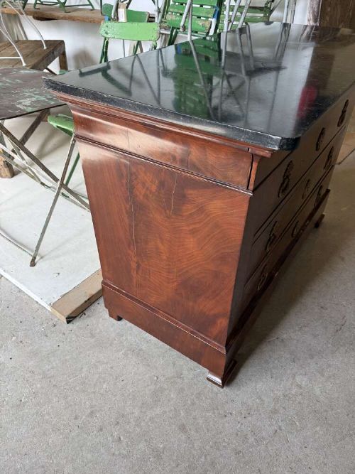 A nineteenth-century mahogany commode featuring three drawers with decorative brass handles and a dark marble top. View VI