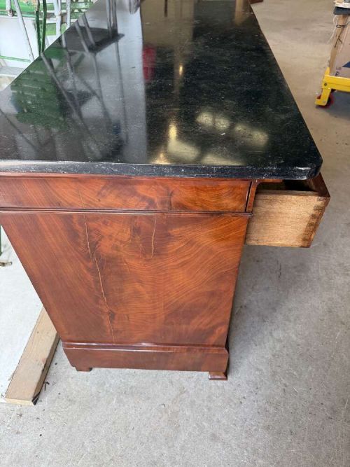 A nineteenth-century mahogany commode featuring three drawers with decorative brass handles and a dark marble top. View VIII