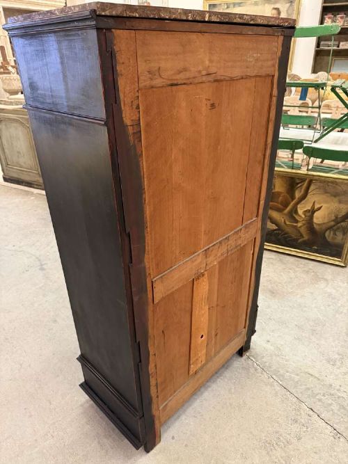 A tall narrow black ebonised chest of drawers featuring seven moulded drawers, turned wooden knobs, and a dark marble top. View XI
