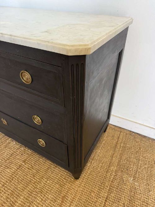 A 19th-century French three-drawer chest of drawers painted black with a white marble top and brass ring handles. View II
