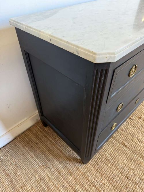 A 19th-century French three-drawer chest of drawers painted black with a white marble top and brass ring handles. View IV