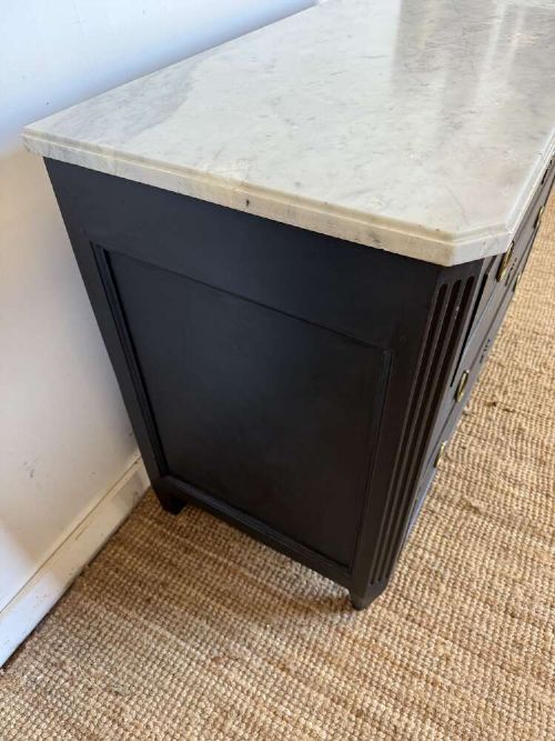 A 19th-century French three-drawer chest of drawers painted black with a white marble top and brass ring handles. View IX