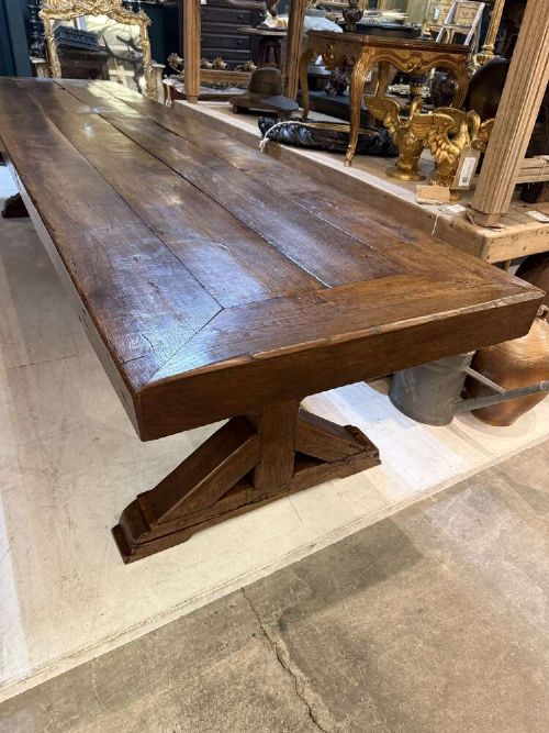 A long late 19th-century French oak refectory table featuring a thick plank top with cleated ends resting on sturdy trestle legs and a stretcher base. View II