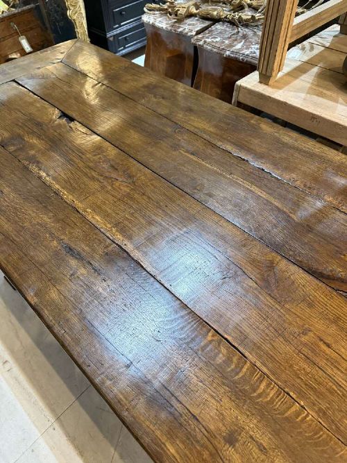 A long late 19th-century French oak refectory table featuring a thick plank top with cleated ends resting on sturdy trestle legs and a stretcher base. View IX