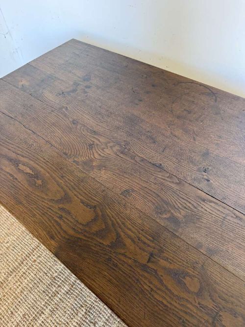 A long dark oak French farmhouse dining table featuring a plank top surface and four tapered square legs. View VIII