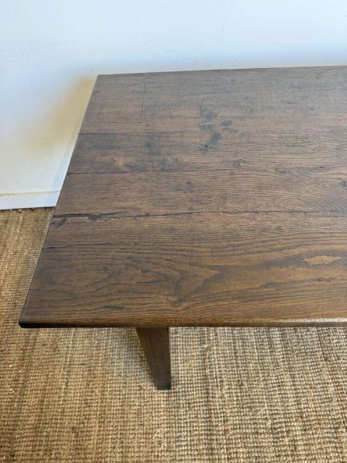 A long dark oak French farmhouse dining table featuring a plank top surface and four tapered square legs. View IX