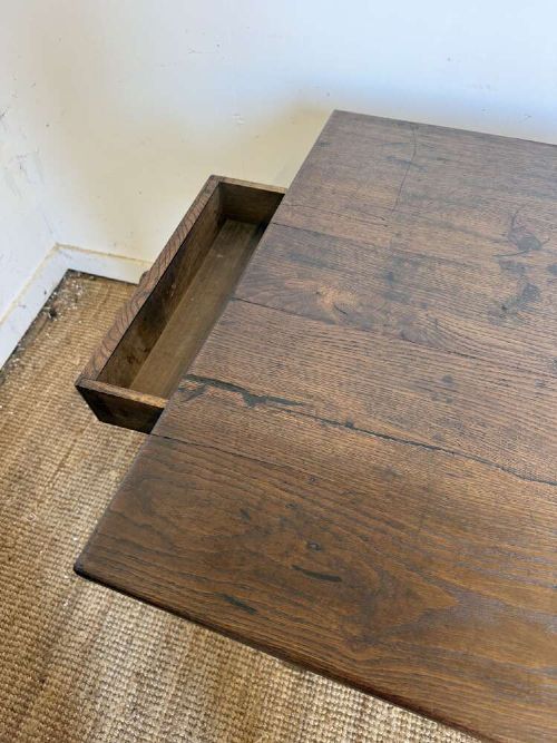 A long dark oak French farmhouse dining table featuring a plank top surface and four tapered square legs. View X