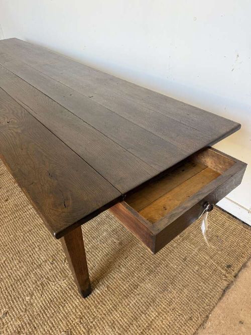 A long dark oak French farmhouse dining table featuring a plank top surface and four tapered square legs. View XI