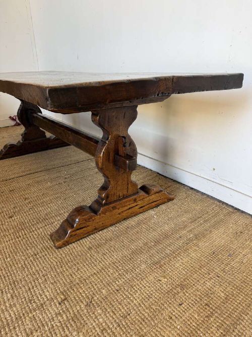 An early 20th century French dark oak refectory table featuring a single plank top supported by a pegged trestle base with a central stretcher. View VIII