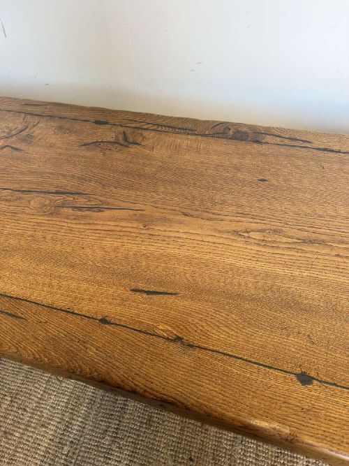 An early 20th-century oak refectory dining table featuring a rectangular framed plank top supported by turned legs on a trestle base with a stretcher rail. View VIII