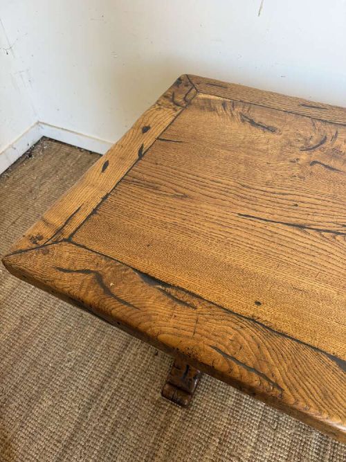 An early 20th-century oak refectory dining table featuring a rectangular framed plank top supported by turned legs on a trestle base with a stretcher rail. View IX