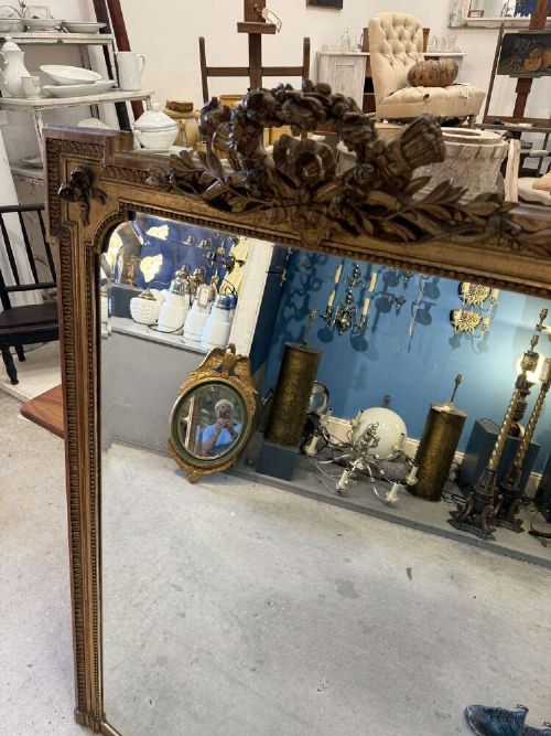 A large 19th-century French Louis Philippe rectangular mirror featuring a gilded frame with rounded top corners, beaded inner moulding, and an ornate floral crest at the top centre. View III