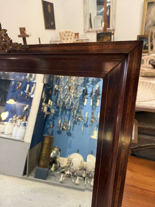 A large rectangular mahogany wall mirror featuring a moulded timber frame and a carved ormolu foliate cresting at the top. View II