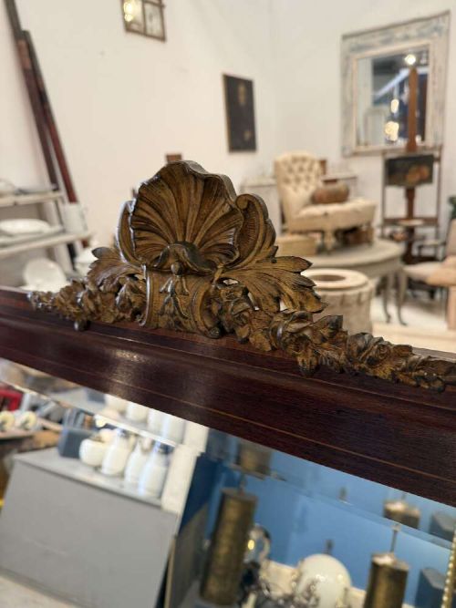 A large rectangular mahogany wall mirror featuring a moulded timber frame and a carved ormolu foliate cresting at the top. View III