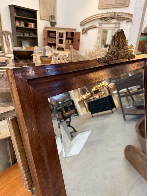A large rectangular mahogany wall mirror featuring a moulded timber frame and a carved ormolu foliate cresting at the top. View IV