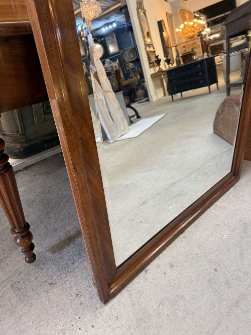 A large rectangular mahogany wall mirror featuring a moulded timber frame and a carved ormolu foliate cresting at the top. View V