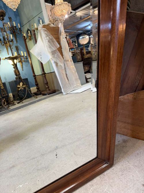 A large rectangular mahogany wall mirror featuring a moulded timber frame and a carved ormolu foliate cresting at the top. View VI