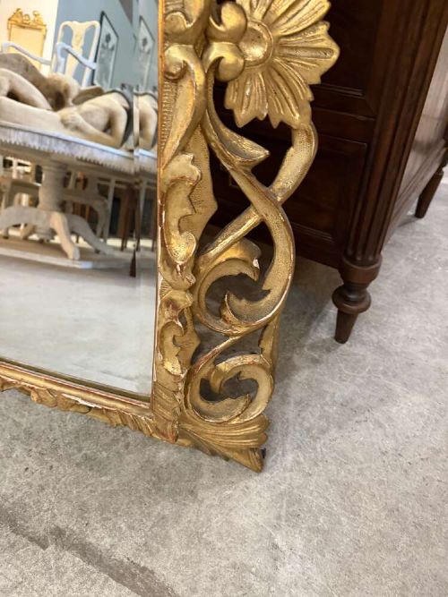 A 19th-century French carved giltwood frame featuring intricate scrollwork, openwork cresting, and a bevelled glass mirror plate. View III