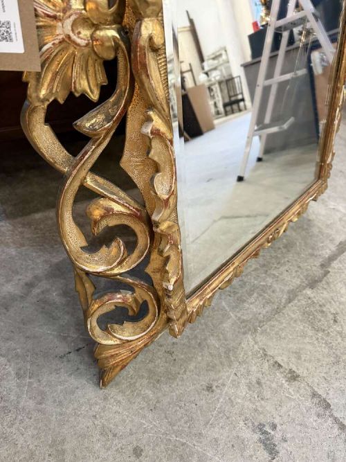 A 19th-century French carved giltwood frame featuring intricate scrollwork, openwork cresting, and a bevelled glass mirror plate. View VII