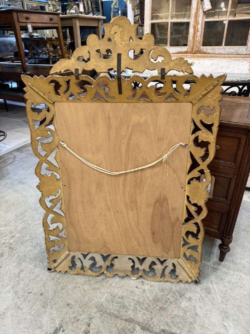A 19th-century French carved giltwood frame featuring intricate scrollwork, openwork cresting, and a bevelled glass mirror plate. View VIII