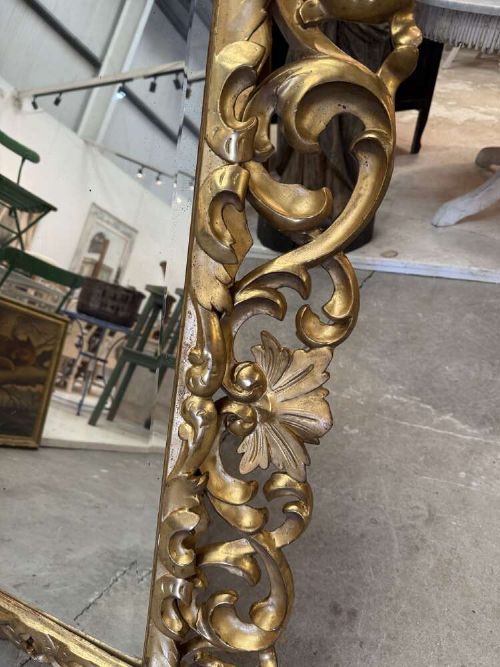 A rectangular mid-19th century French mirror featuring an elaborate, pierced carved gilded wood frame decorated with acanthus leaves and scrollwork. View III