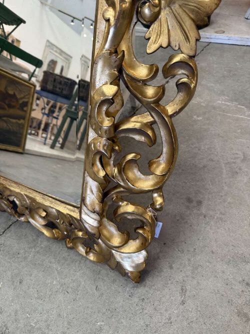 A rectangular mid-19th century French mirror featuring an elaborate, pierced carved gilded wood frame decorated with acanthus leaves and scrollwork. View IV