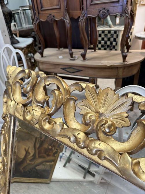 A rectangular mid-19th century French mirror featuring an elaborate, pierced carved gilded wood frame decorated with acanthus leaves and scrollwork. View V