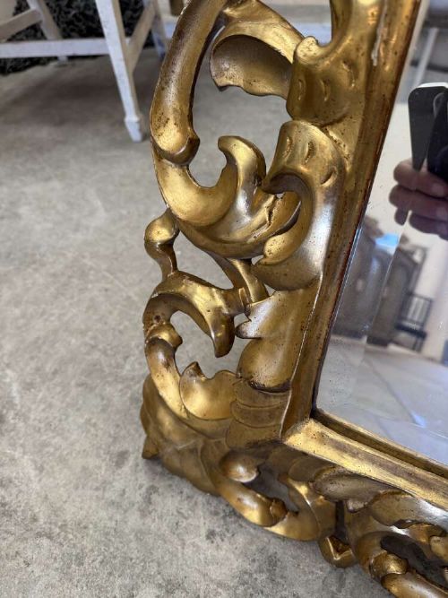 A rectangular mid-19th century French mirror featuring an elaborate, pierced carved gilded wood frame decorated with acanthus leaves and scrollwork. View VII