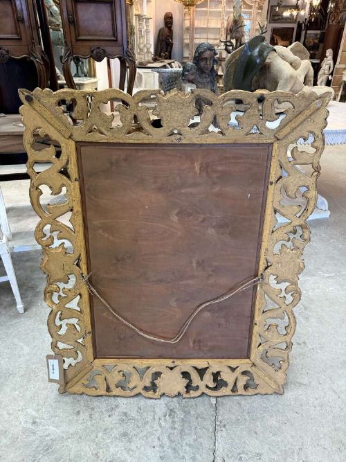 A rectangular mid-19th century French mirror featuring an elaborate, pierced carved gilded wood frame decorated with acanthus leaves and scrollwork. View VIII