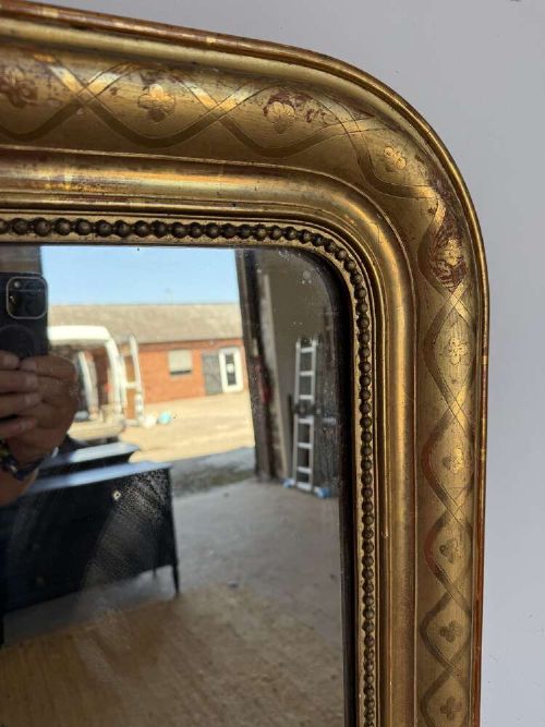 A late nineteenth-century French rectangular wall mirror featuring rounded upper corners, an incised gold gilt frame, and a beaded inner border. View II