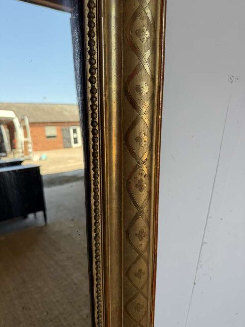 A late nineteenth-century French rectangular wall mirror featuring rounded upper corners, an incised gold gilt frame, and a beaded inner border. View III