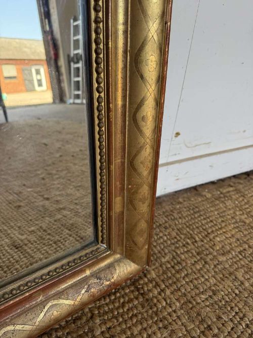A late nineteenth-century French rectangular wall mirror featuring rounded upper corners, an incised gold gilt frame, and a beaded inner border. View V