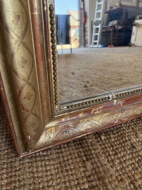 A late nineteenth-century French rectangular wall mirror featuring rounded upper corners, an incised gold gilt frame, and a beaded inner border. View IX
