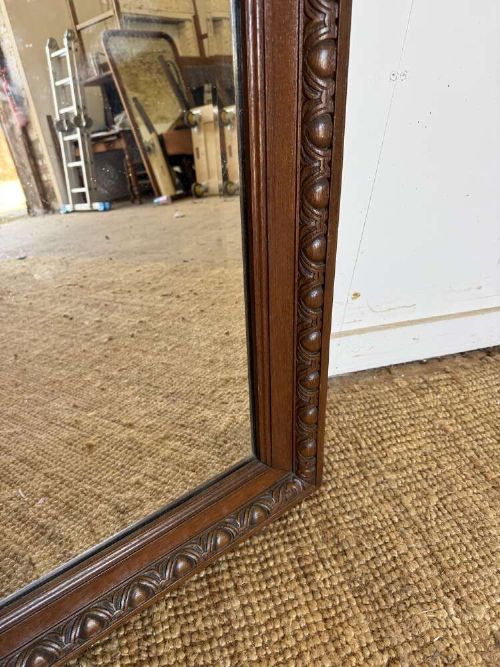 A late 19th-century French carved oak wall mirror with rounded top corners and detailed carved egg and dart moulding along the frame. View III