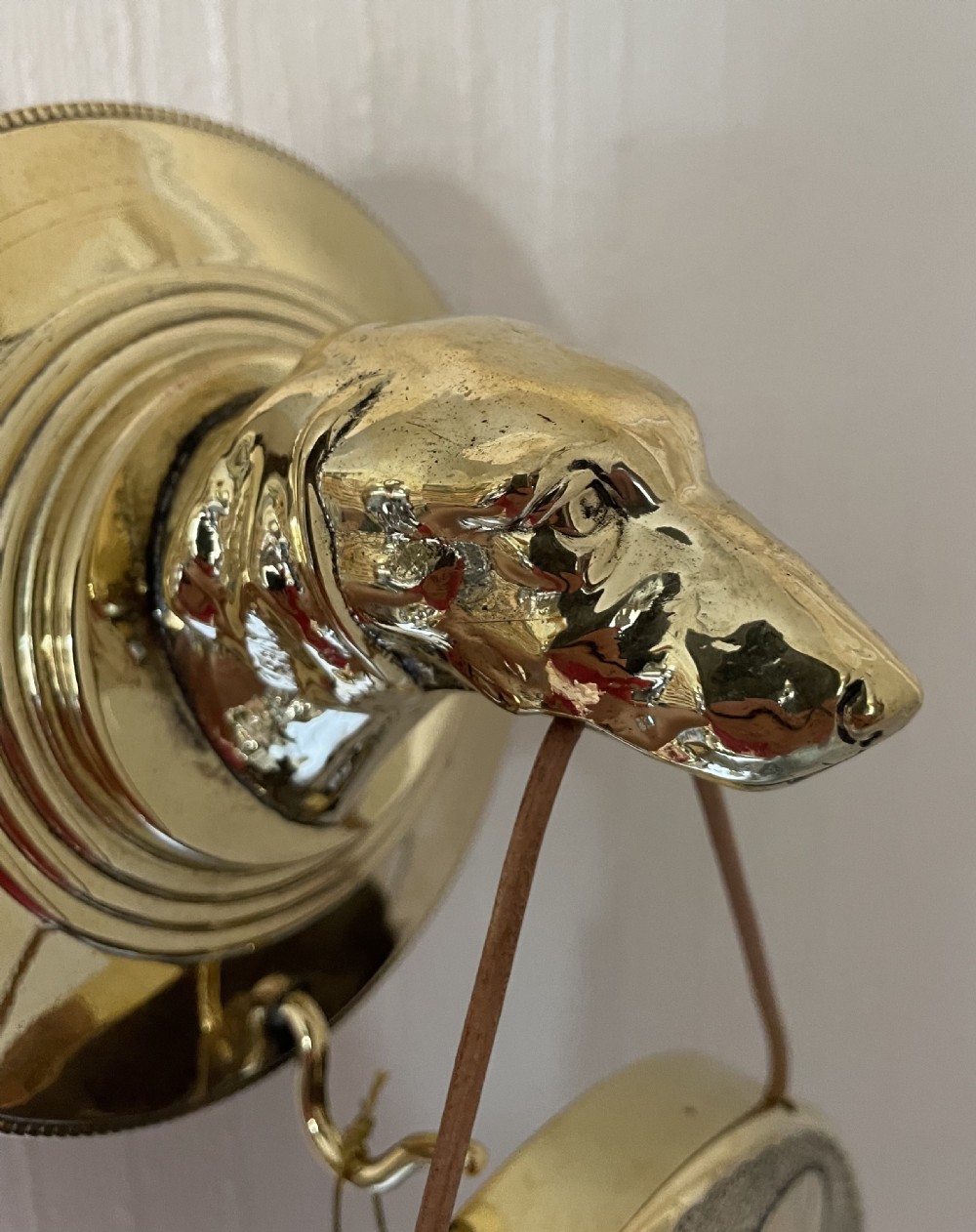 WALL MOUNTED GONG HELD IN DOG’S MOUTH View VI