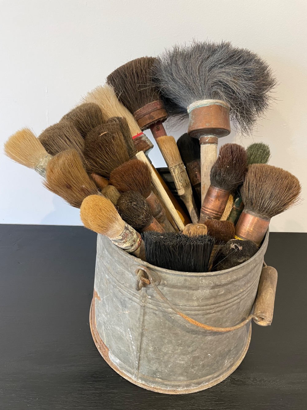 Collection of  paint brushes ina zinc bucket 