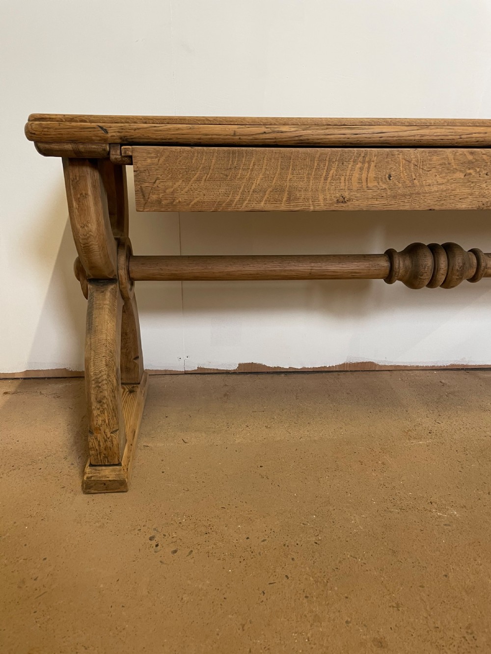 A Victorian oak window seat featuring arched Gothic Revival end legs, two frieze drawers, and a central turned stretcher. View II